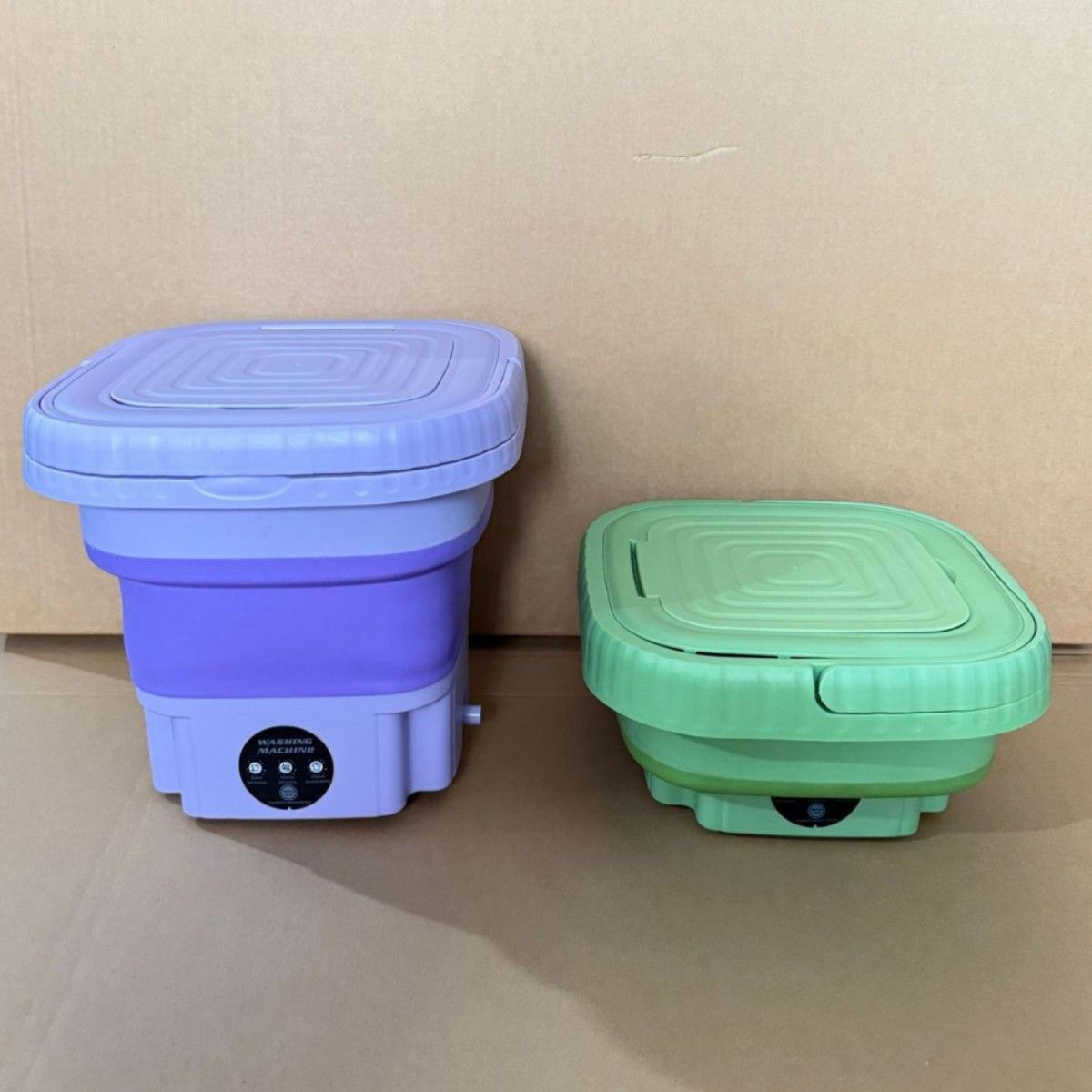 Purple and green collapsible buckets with lids on a beige background